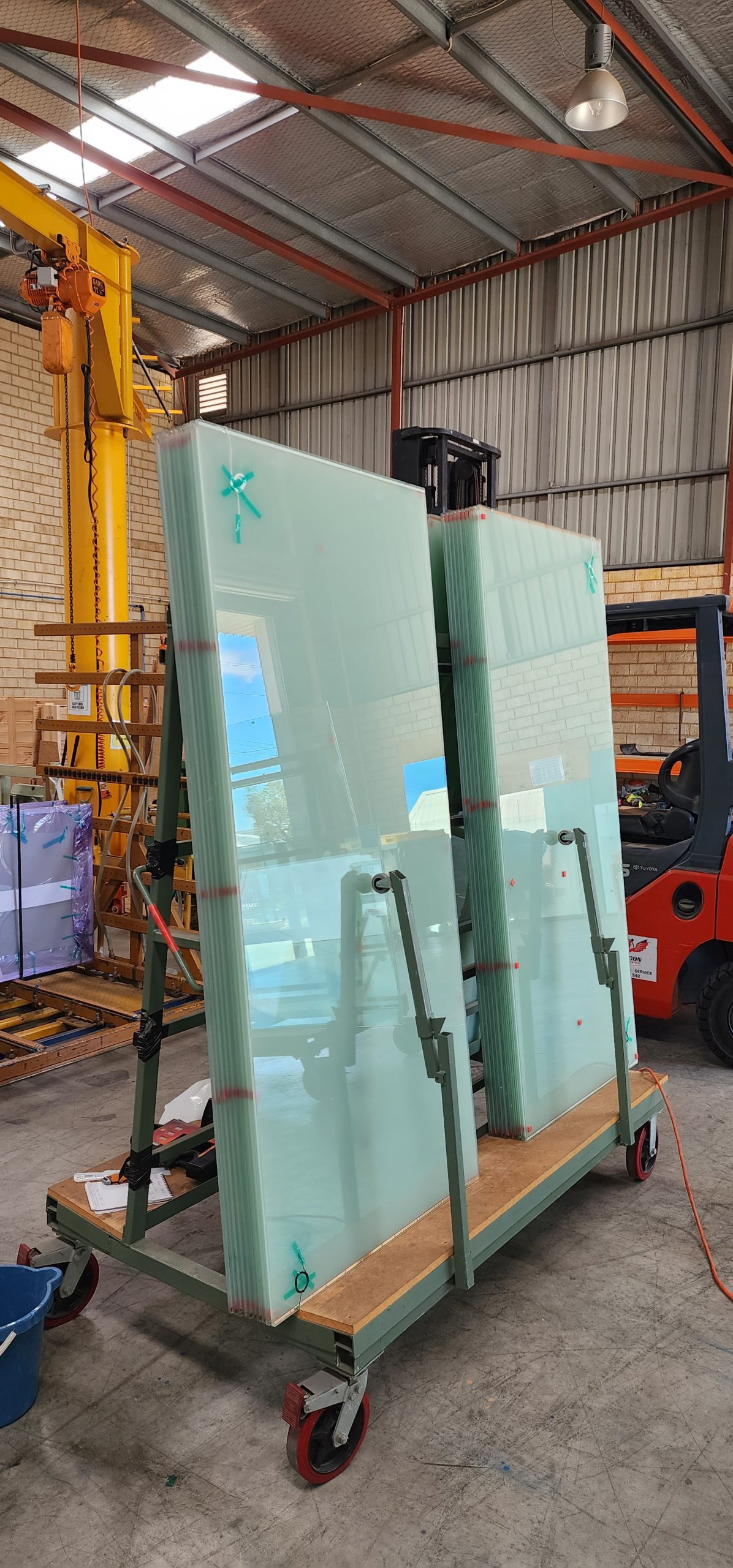 “Switchable glass panels stored in a workshop, ready for testing and installation.”